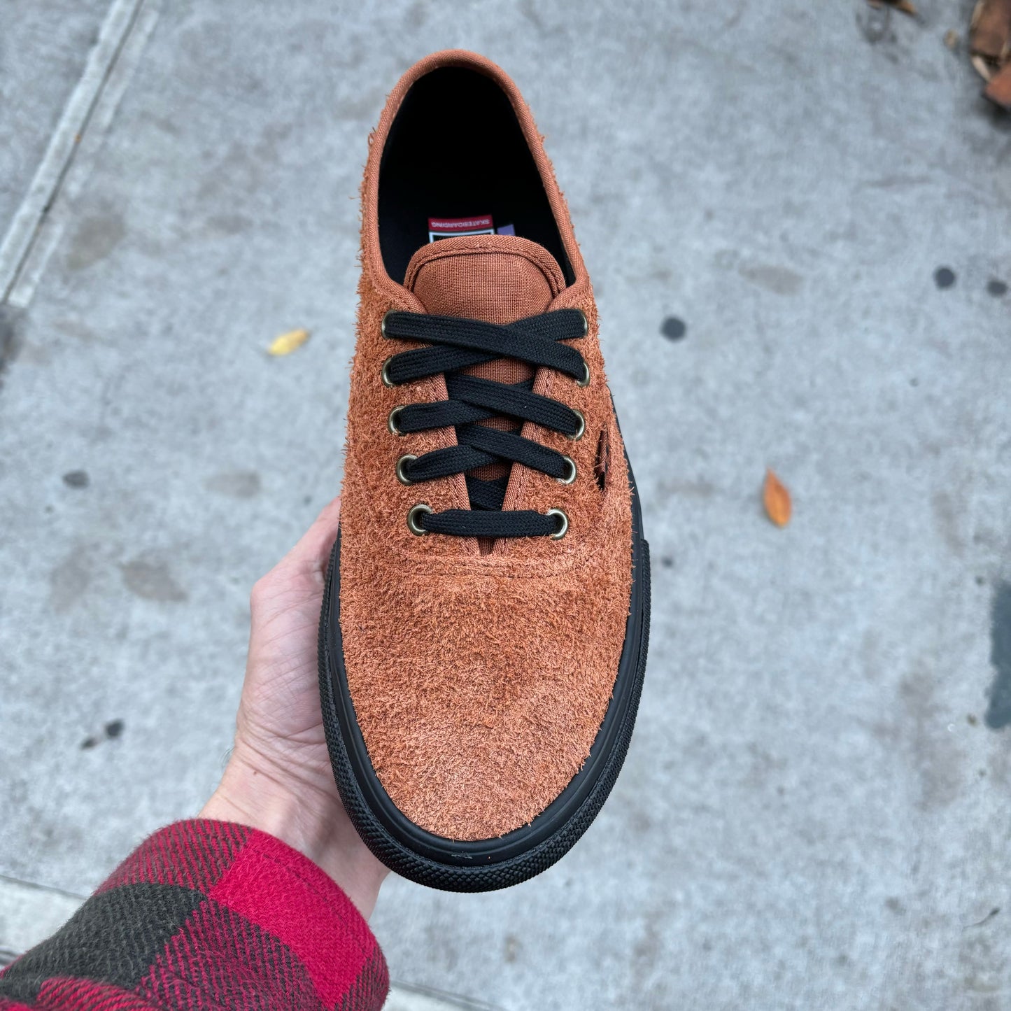 top down view of brown hairy suede sneaker with black sole and black laces