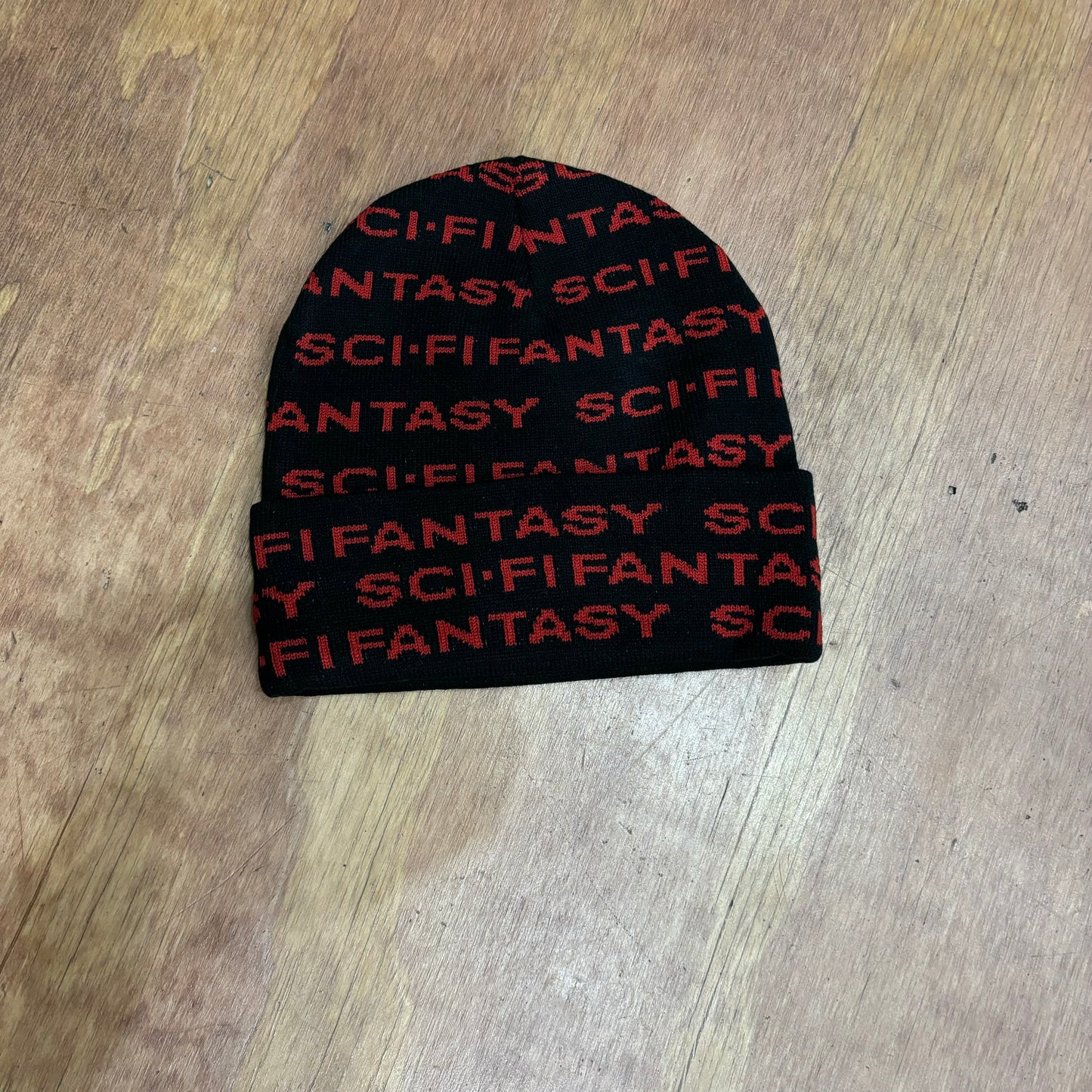 Black and red repeated SCI FI FANTASY written on beanie