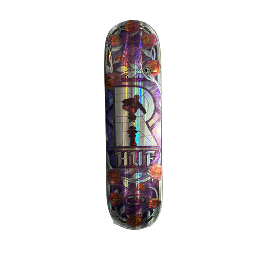 Colorful skateboard deck with HUF logo on a white surface