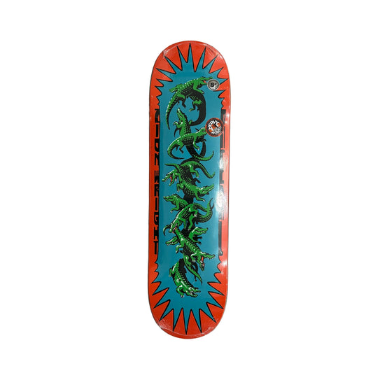 Skateboard deck with green lizard design on a white background