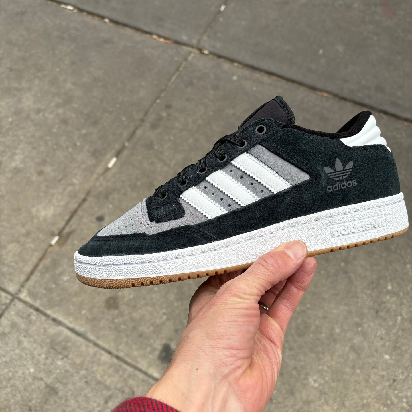 side view of black/white/grey suede sneaker with white and gum sole