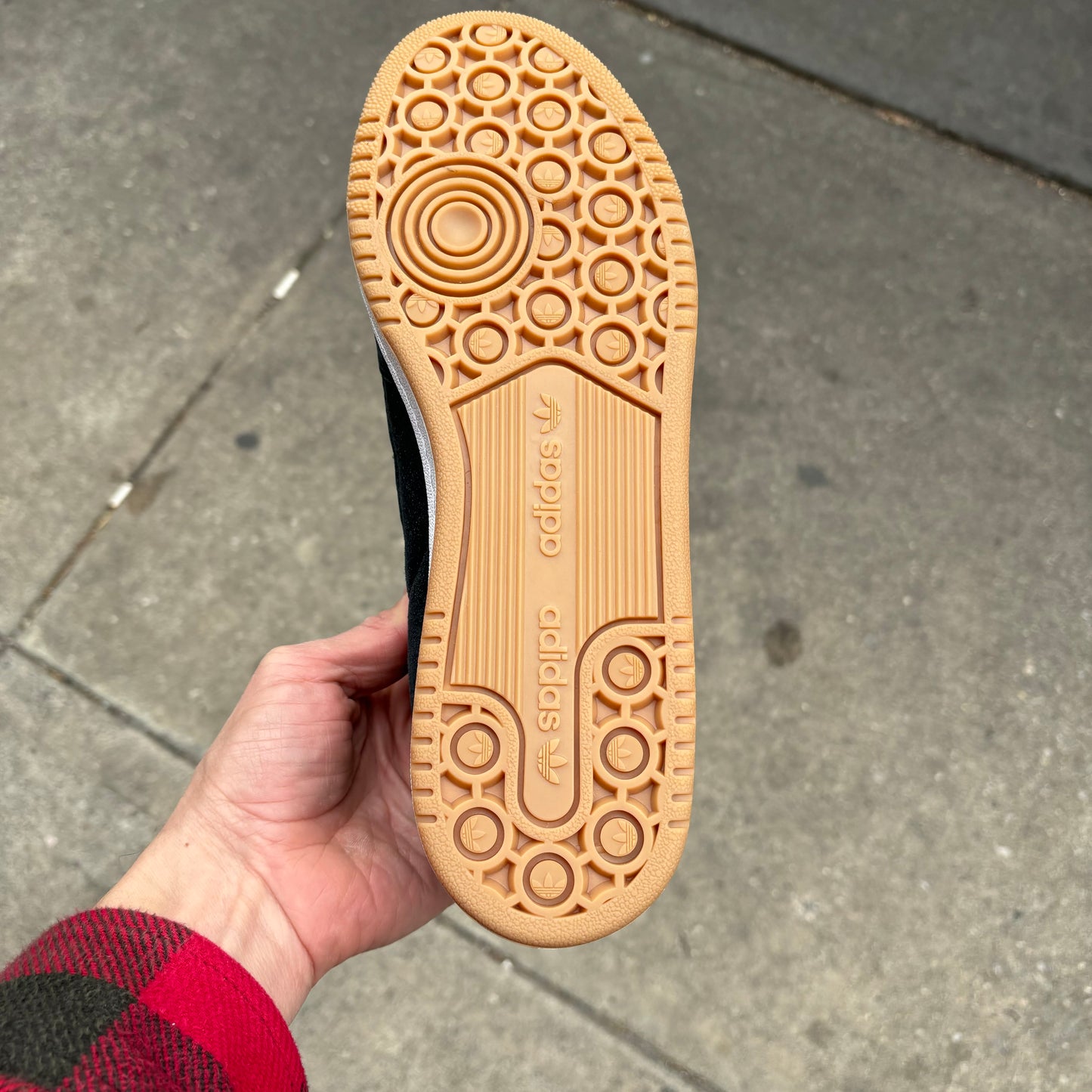 view of bottom of gum sole on black/white/grey skateboard sneaker