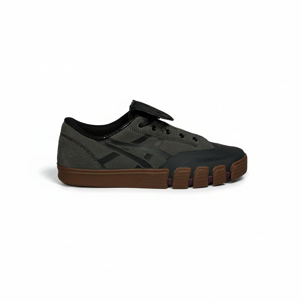 Gray and black sneaker with brown sole on a white background