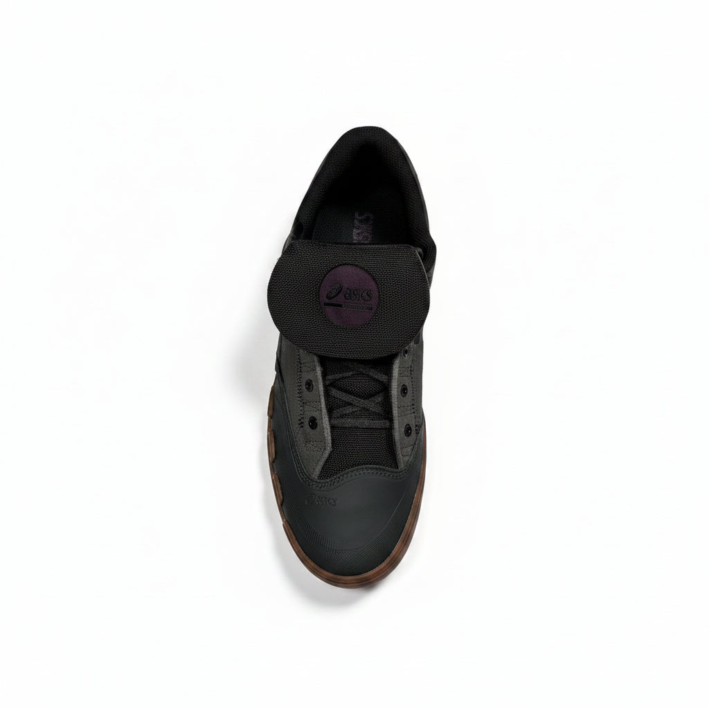 Black sneaker with an asics brand logo on a white background