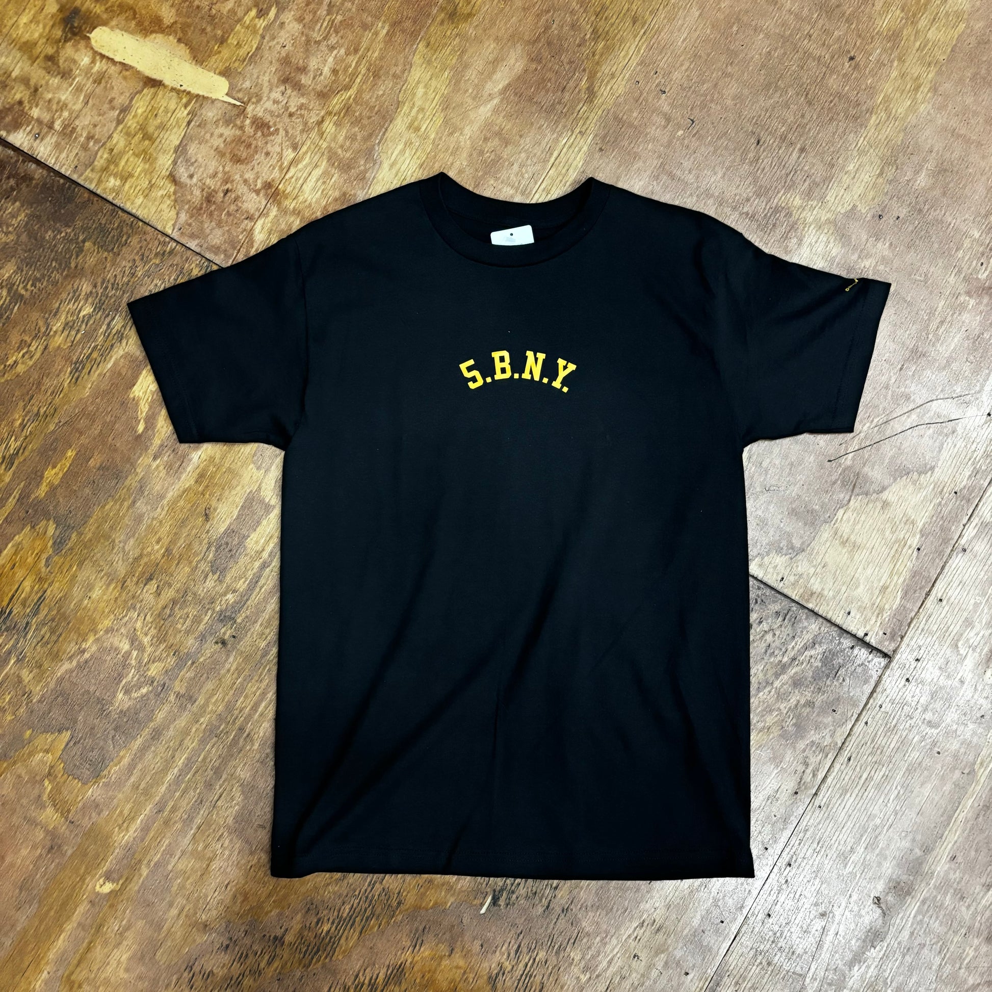 black t-shirt with gold 5.B.N.Y. arch style logo written on it