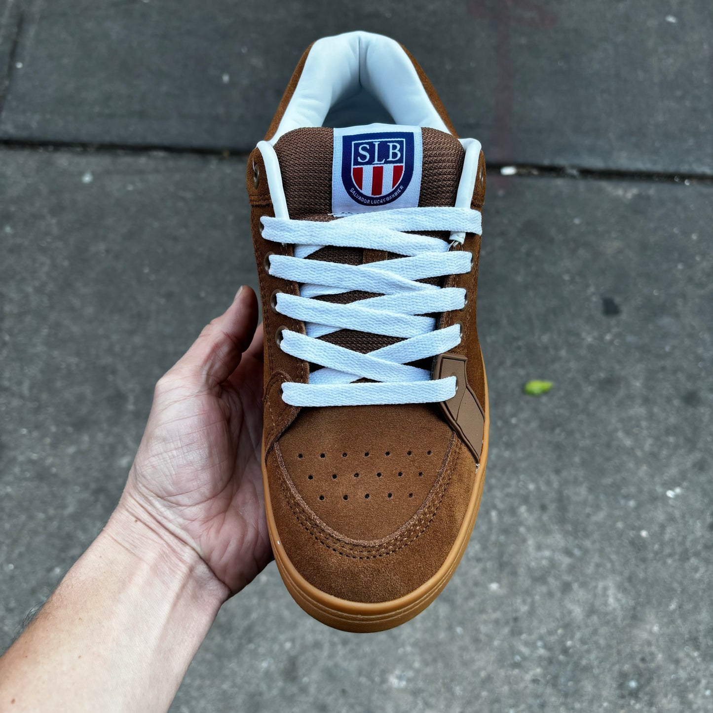 top down view of brown suede shoe with white laces