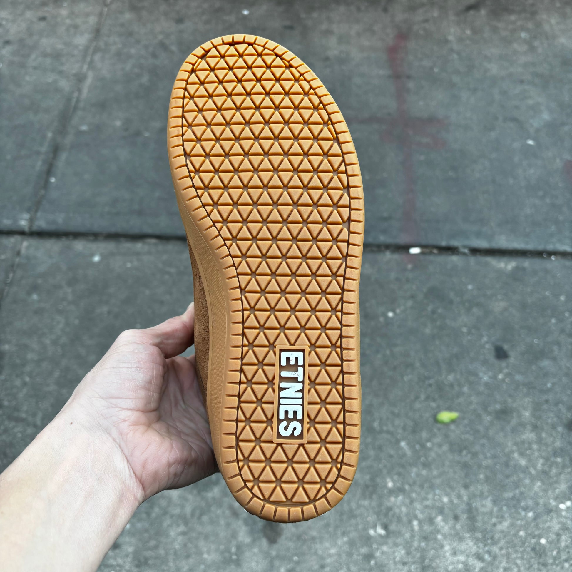 view of gum rubber sole on brown suede sneaker