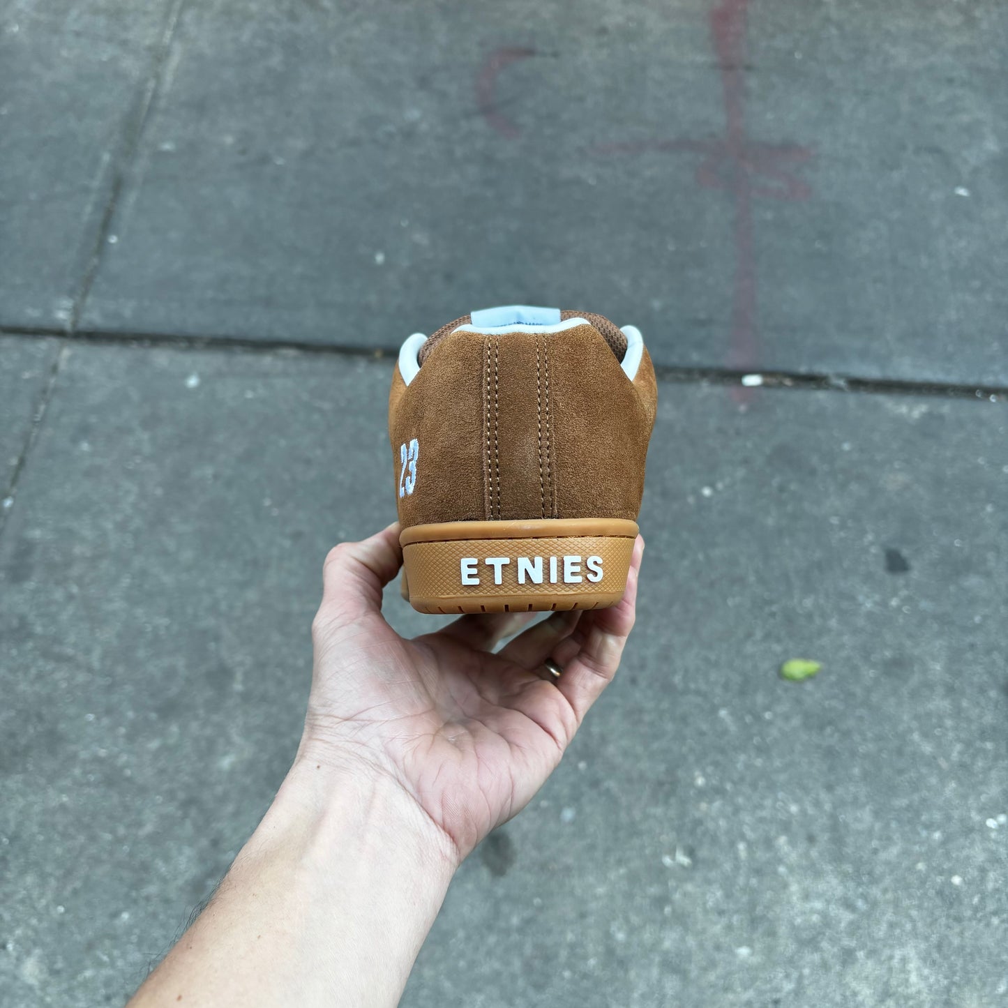 rear heel tab view of brown suede and gum runner sole shoe