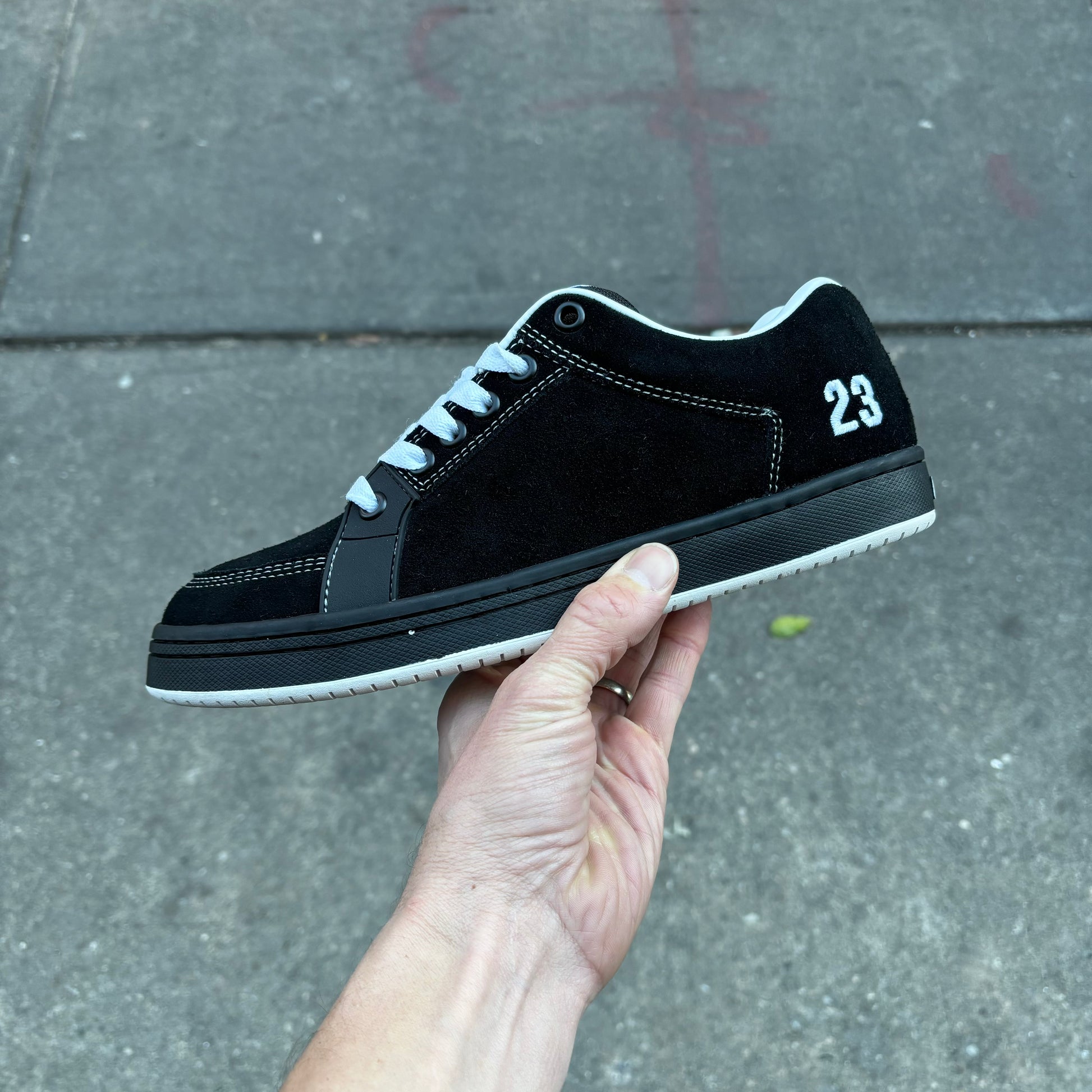 side view of black and white suede skateboard sneaker 