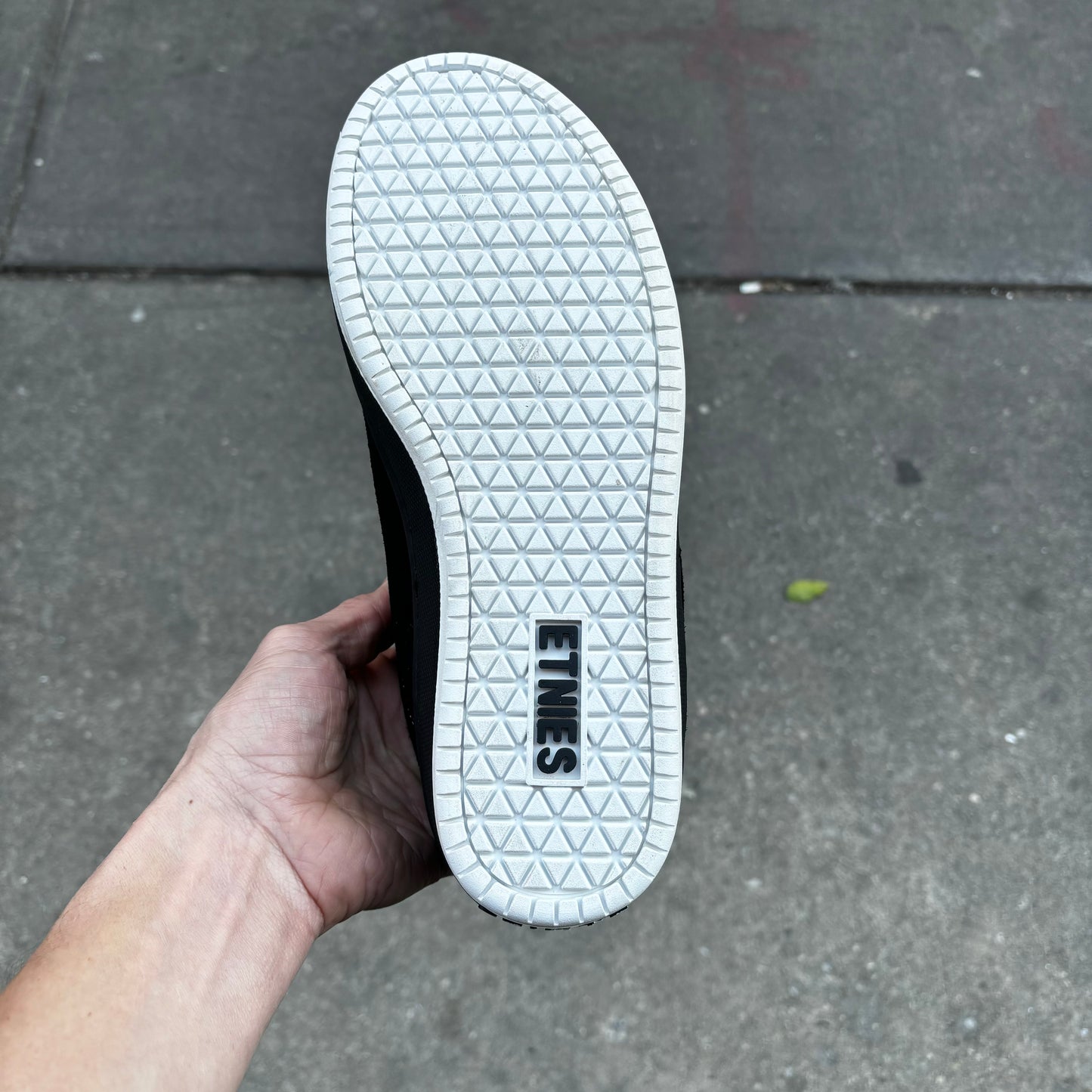 view of white outsole on black and white sneaker