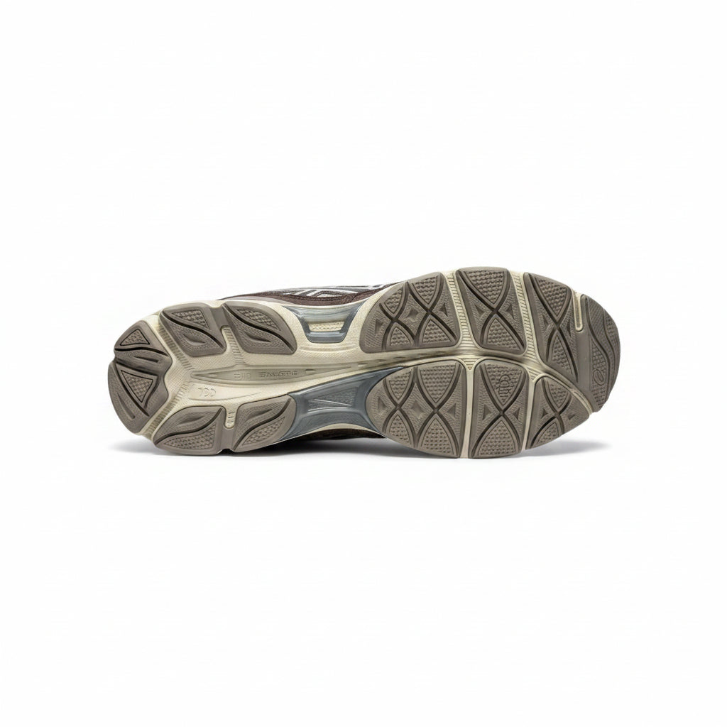 Sole of a running shoe on a gray background