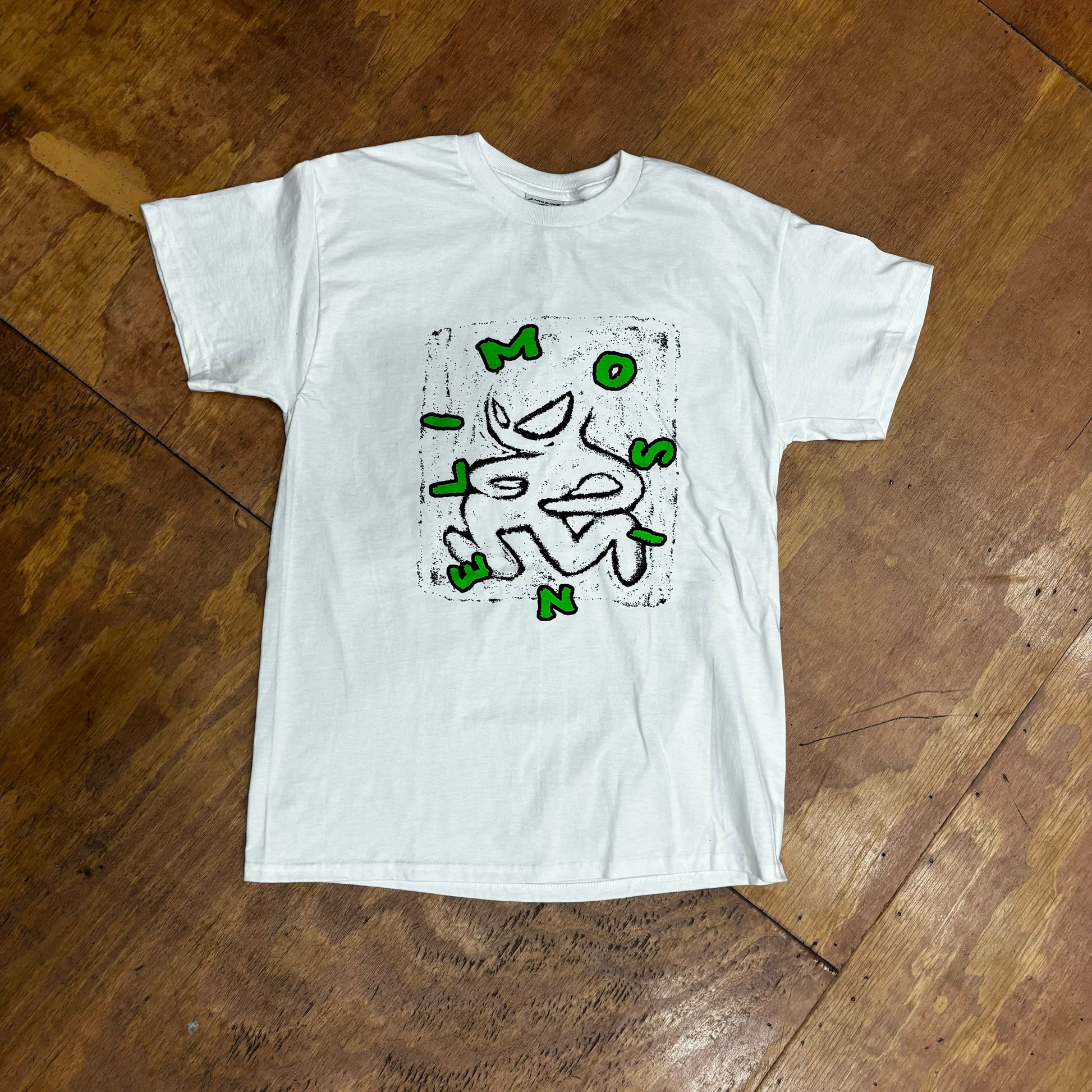 green and black hand drawn logo on white t-shirt