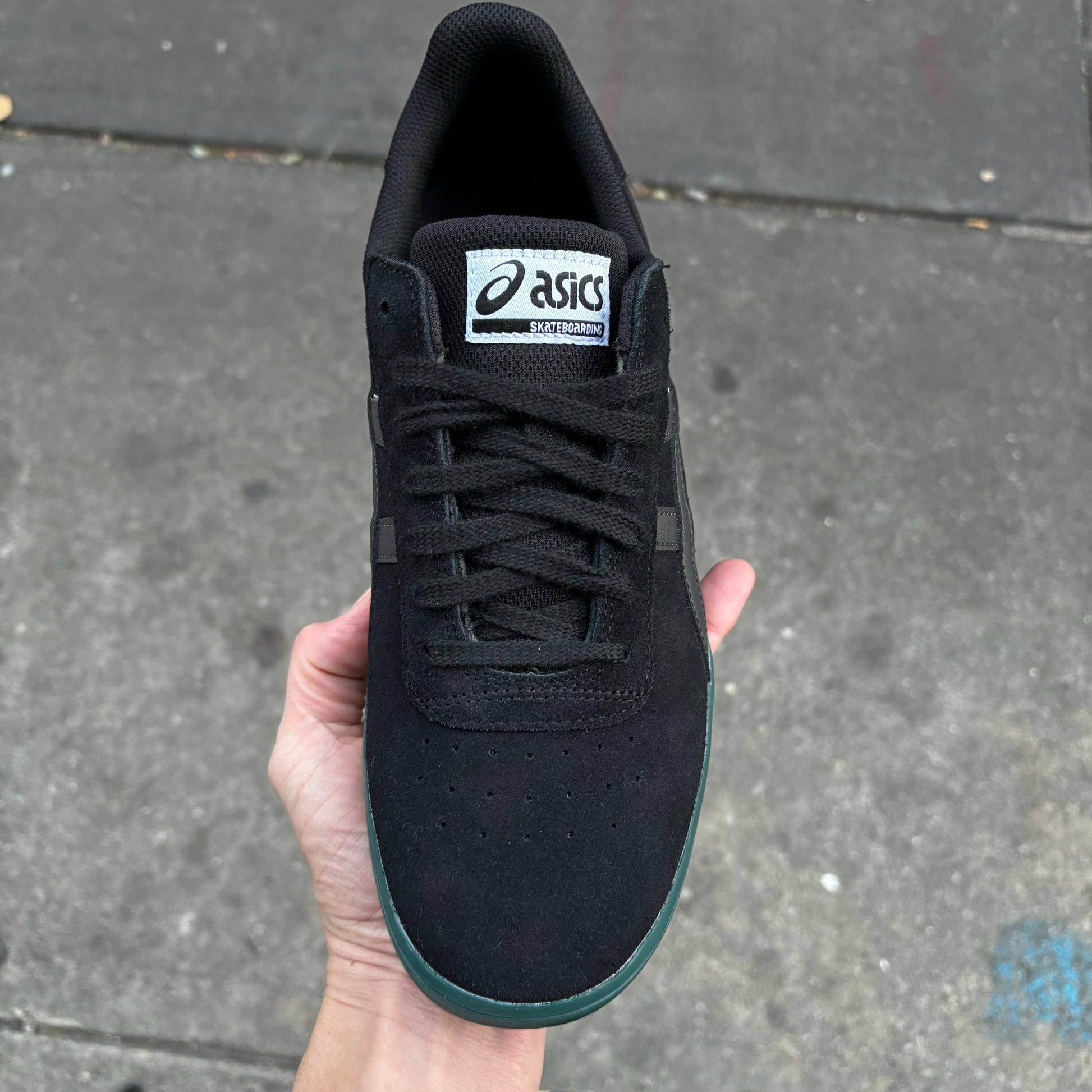 top down view of black suede shoe with black laces