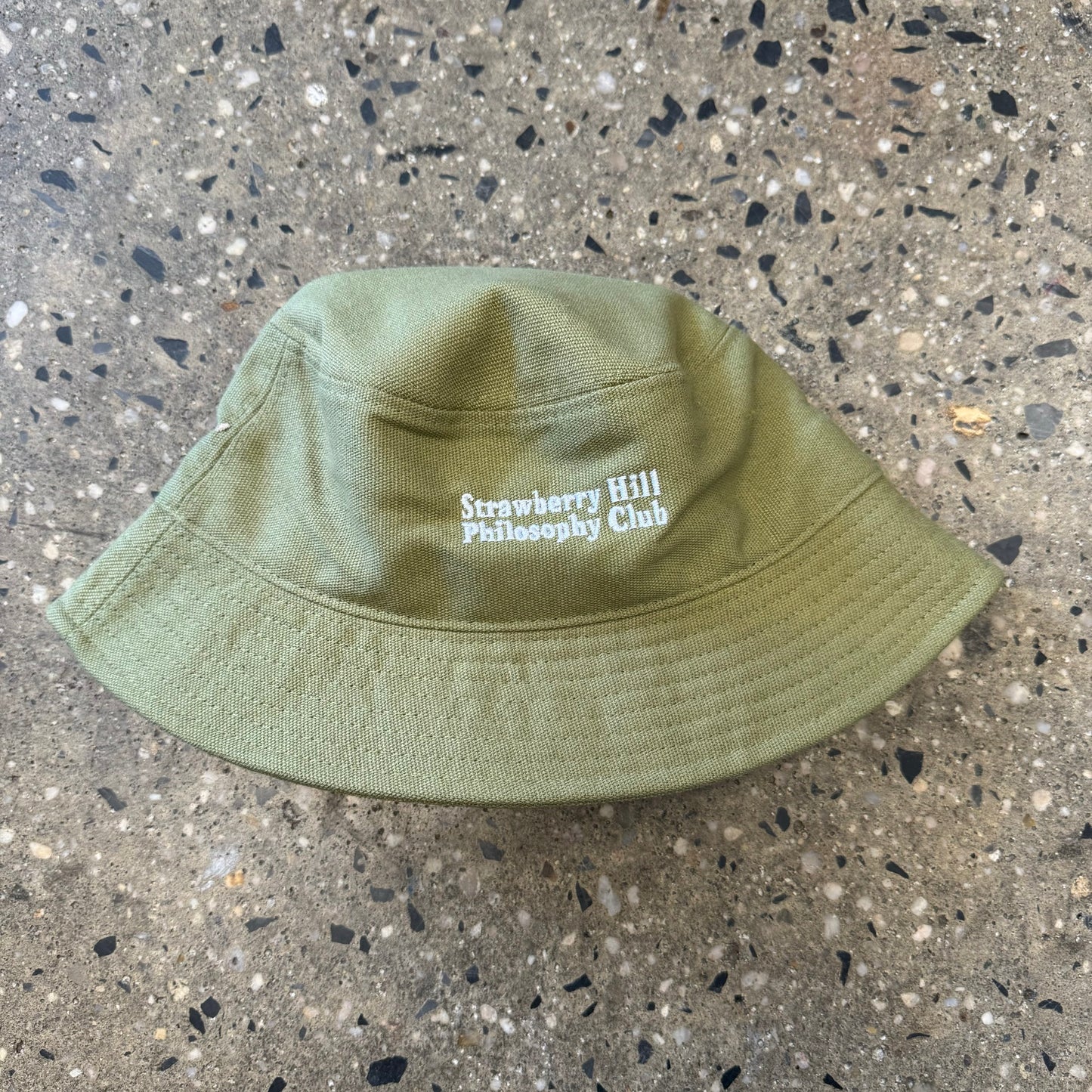 olive green bucket hat with white text