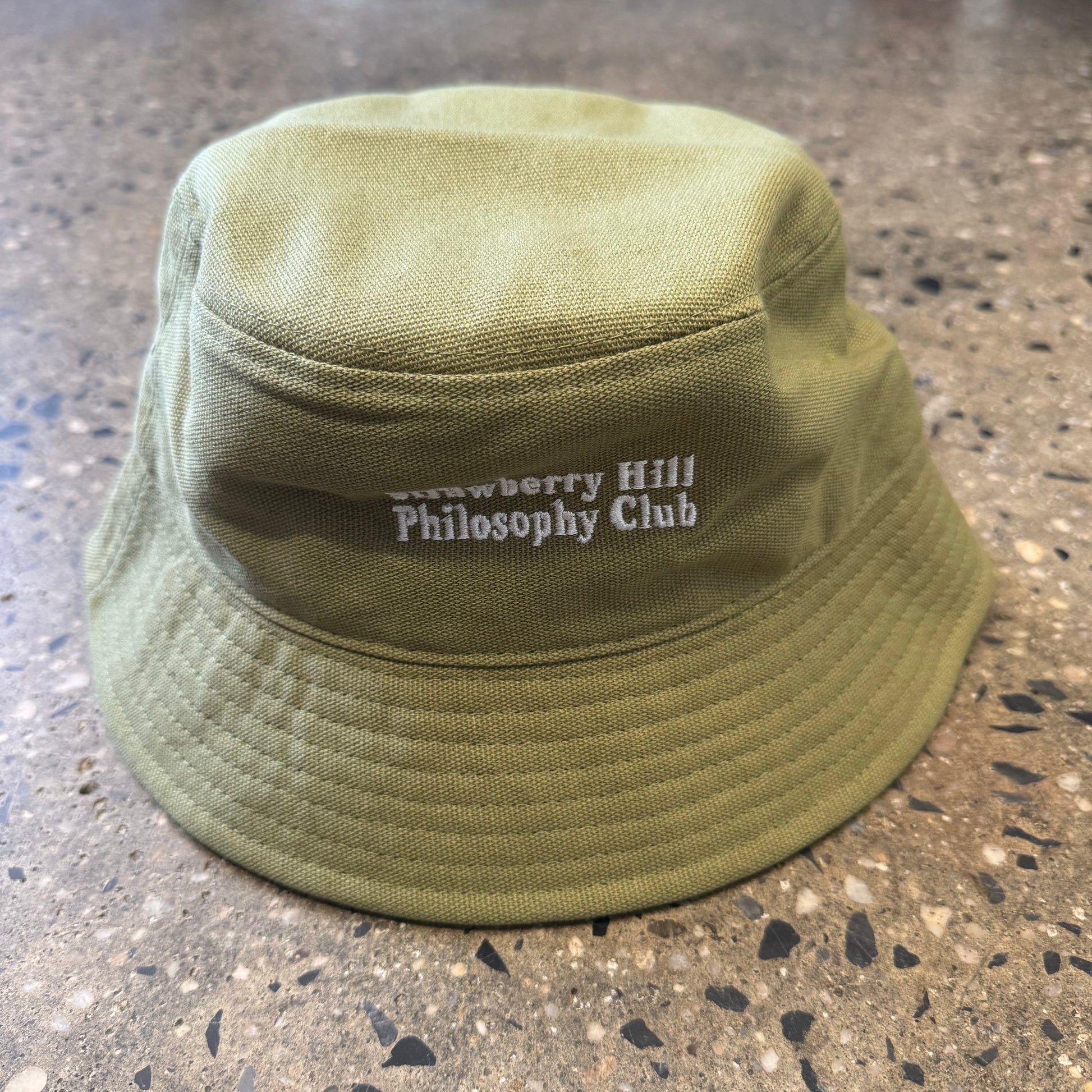 second photo olive green bucket hat white text