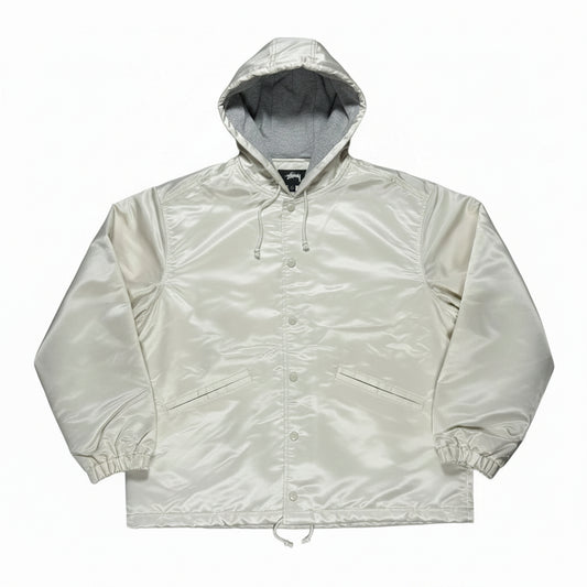 Light-colored coaches jacket on a white background