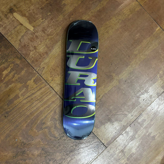 DURAO printed vertically on metallic silver and green on navy metallic skateboard deck