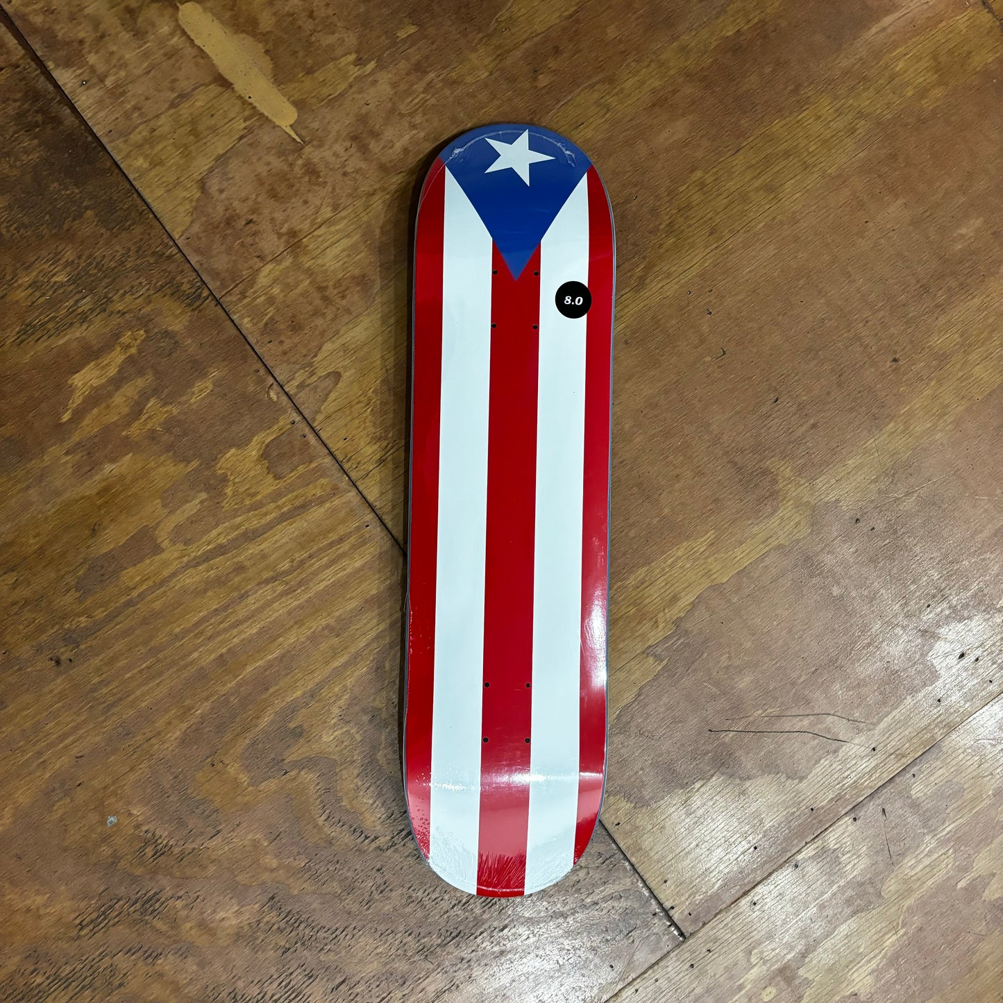 overview of puerto rican flag graphic top to bottom on skateboard deck