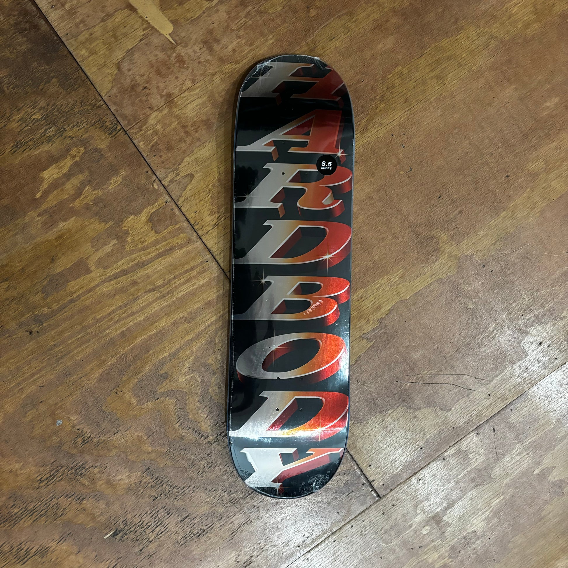 HARDBODY printed in metallic red and silver, on black metallic skateboard deck