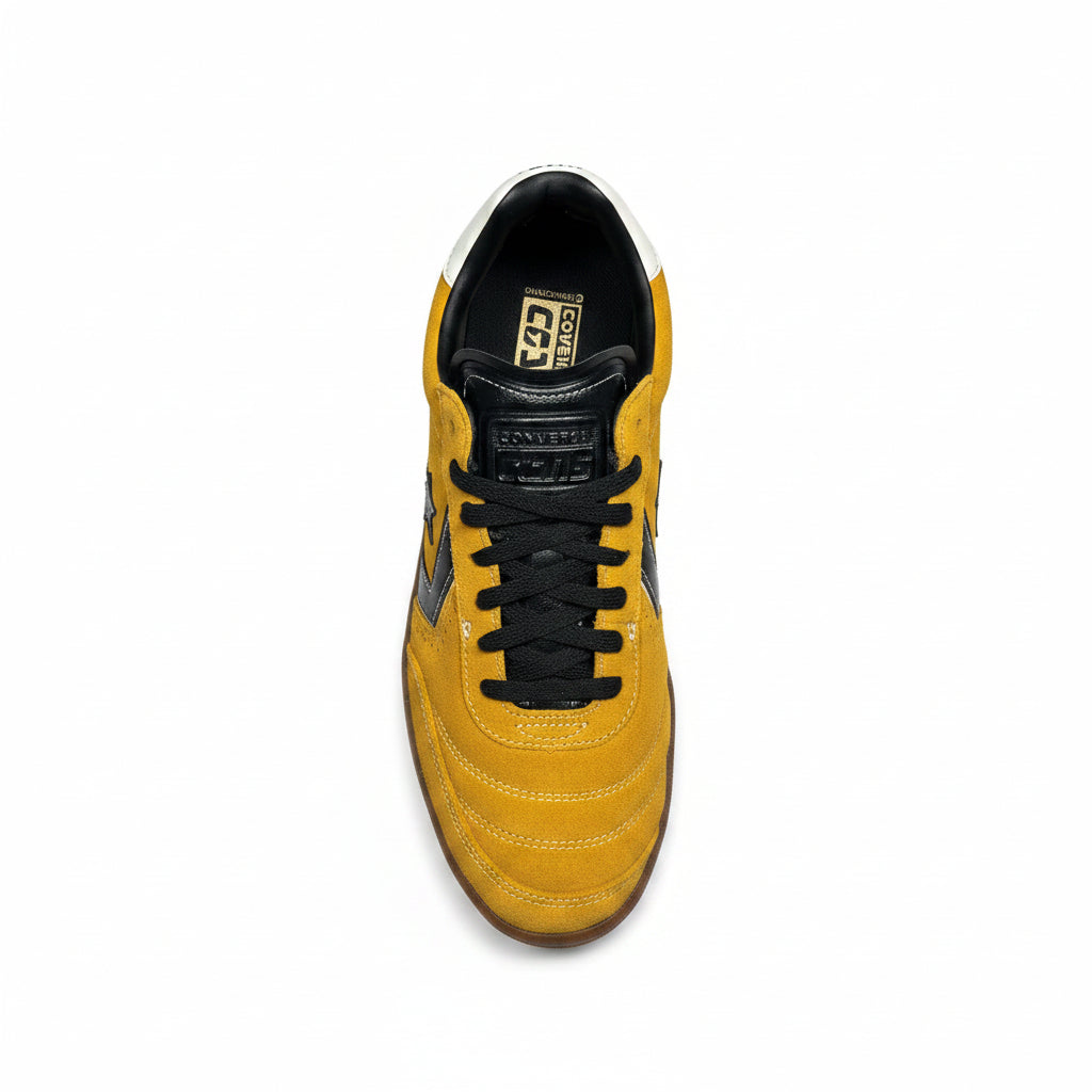 top down view of Yellow converse skateboard shoe with black laces on a white surface
