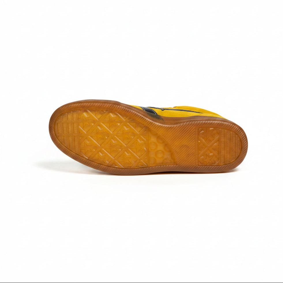 Close-up of a clear shoe sole with brown tread pattern on a white background