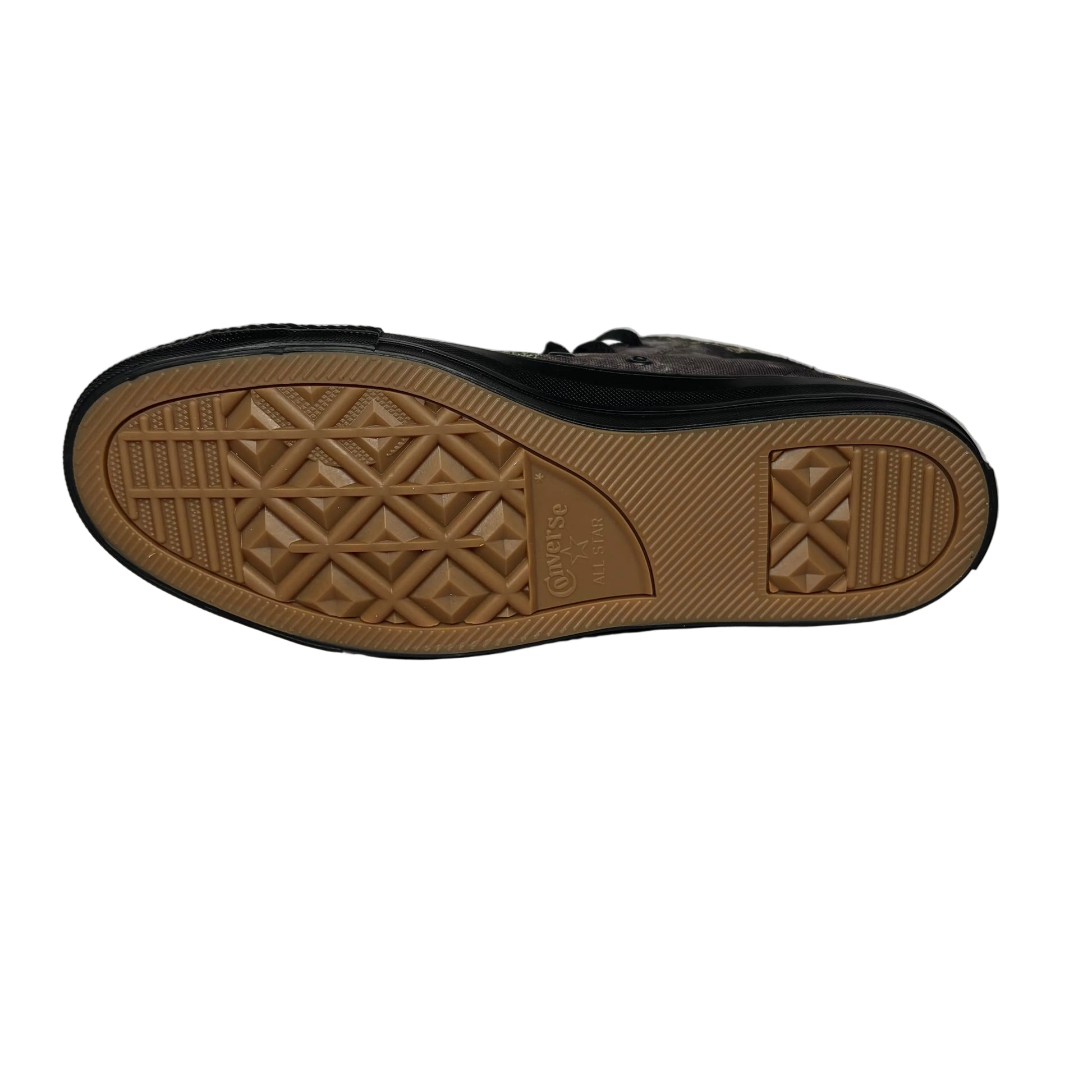 Black sneaker with brown sole on a white  background