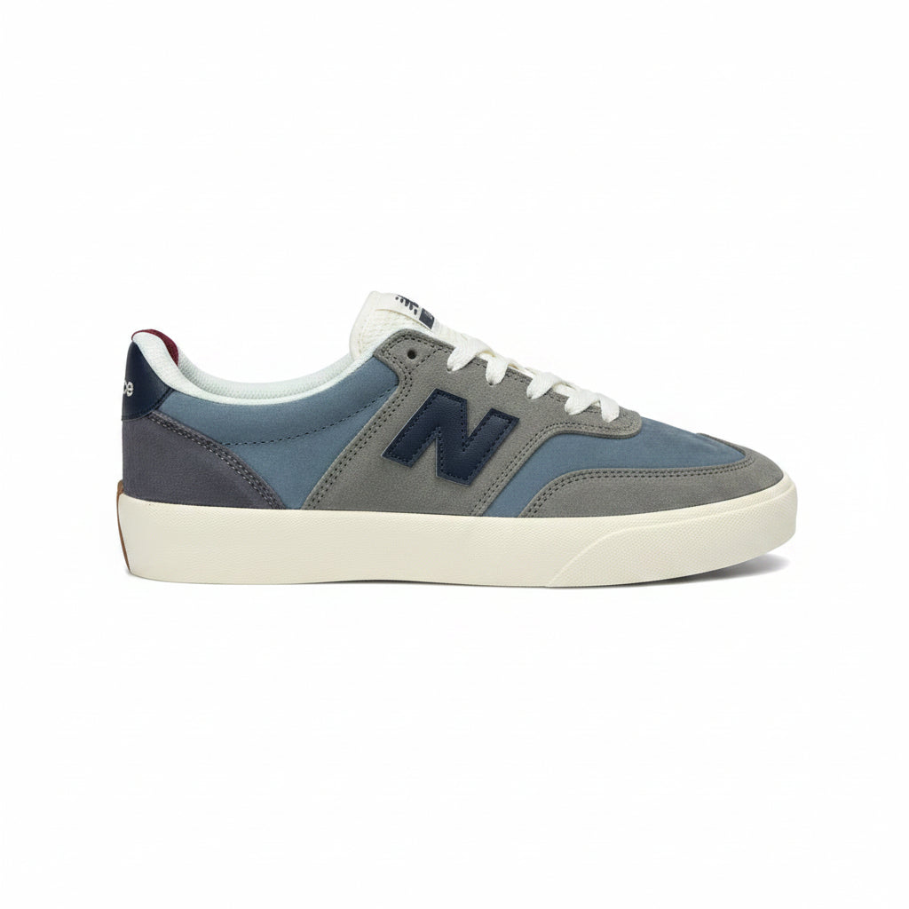 Gray and blue sneaker with a prominent 'N' logo on a white background