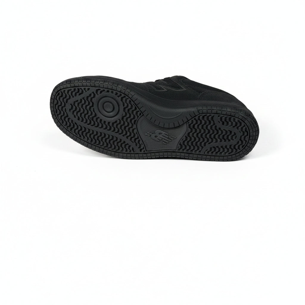 Black sneaker on a gray textured background