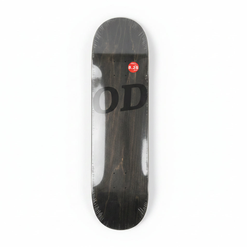 Black skateboard deck with 'OD' branding on a white surface