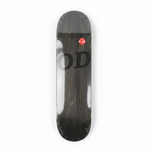 Black skateboard deck with 'OD' branding on a white surface