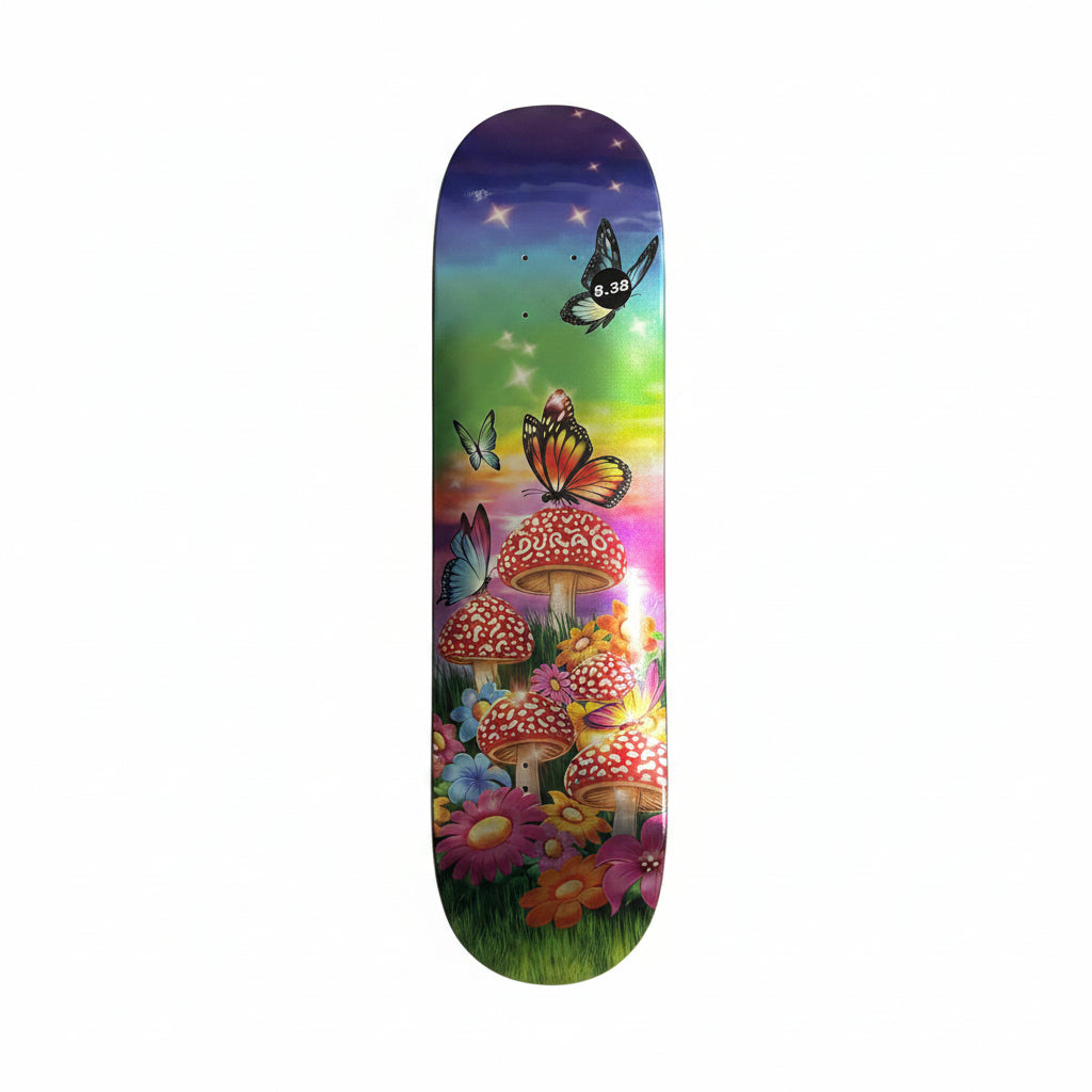 Skateboard deck with a metallic colorful mushroom and butterfly design on a white surface.