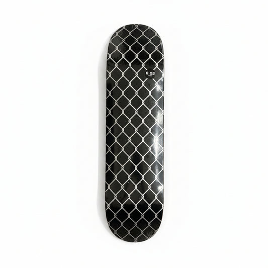 Black diamond-patterned skateboard deck on a white surface