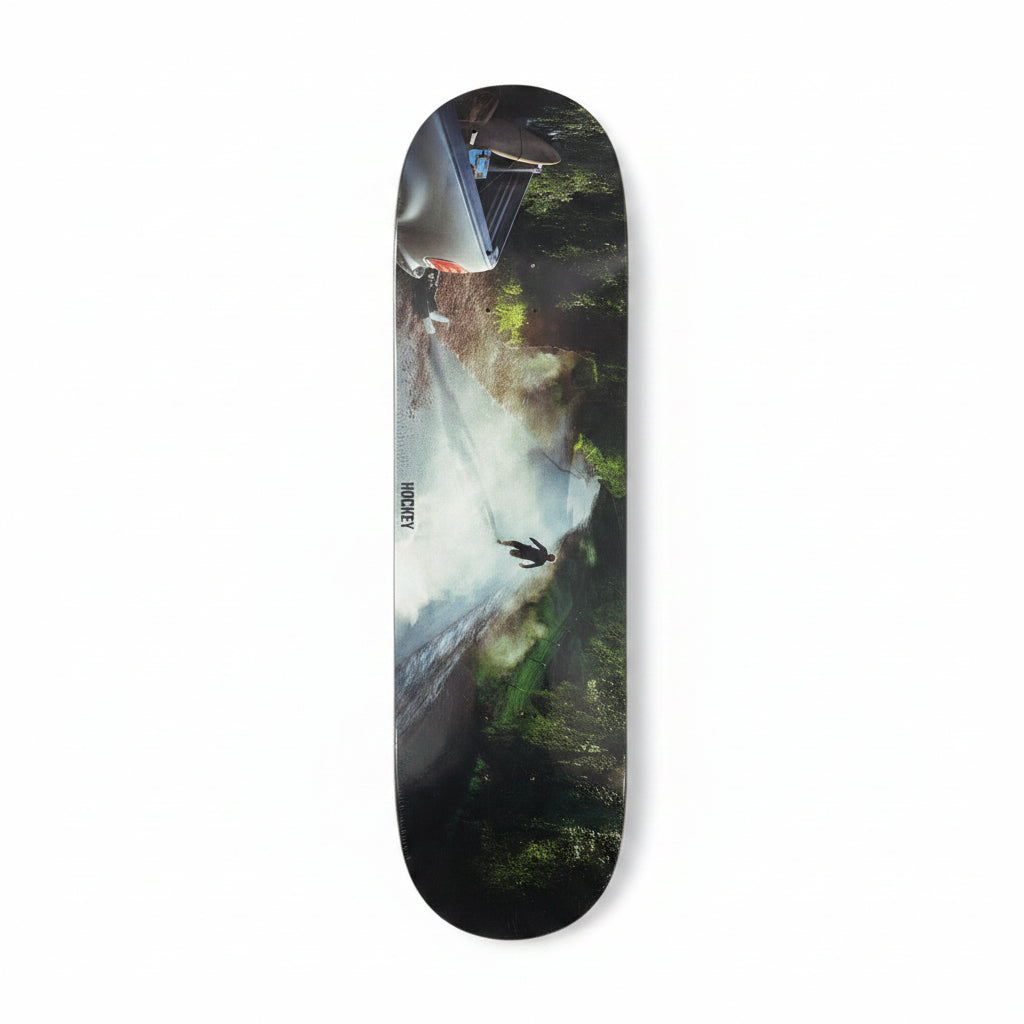 Skateboard deck with a nature-themed photo design on a white surface
