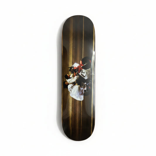 Skateboard deck with a graphic design on a white surface