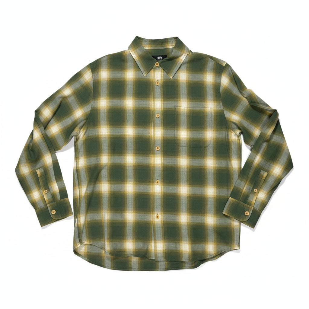 Green and yellow plaid shirt on a white surface