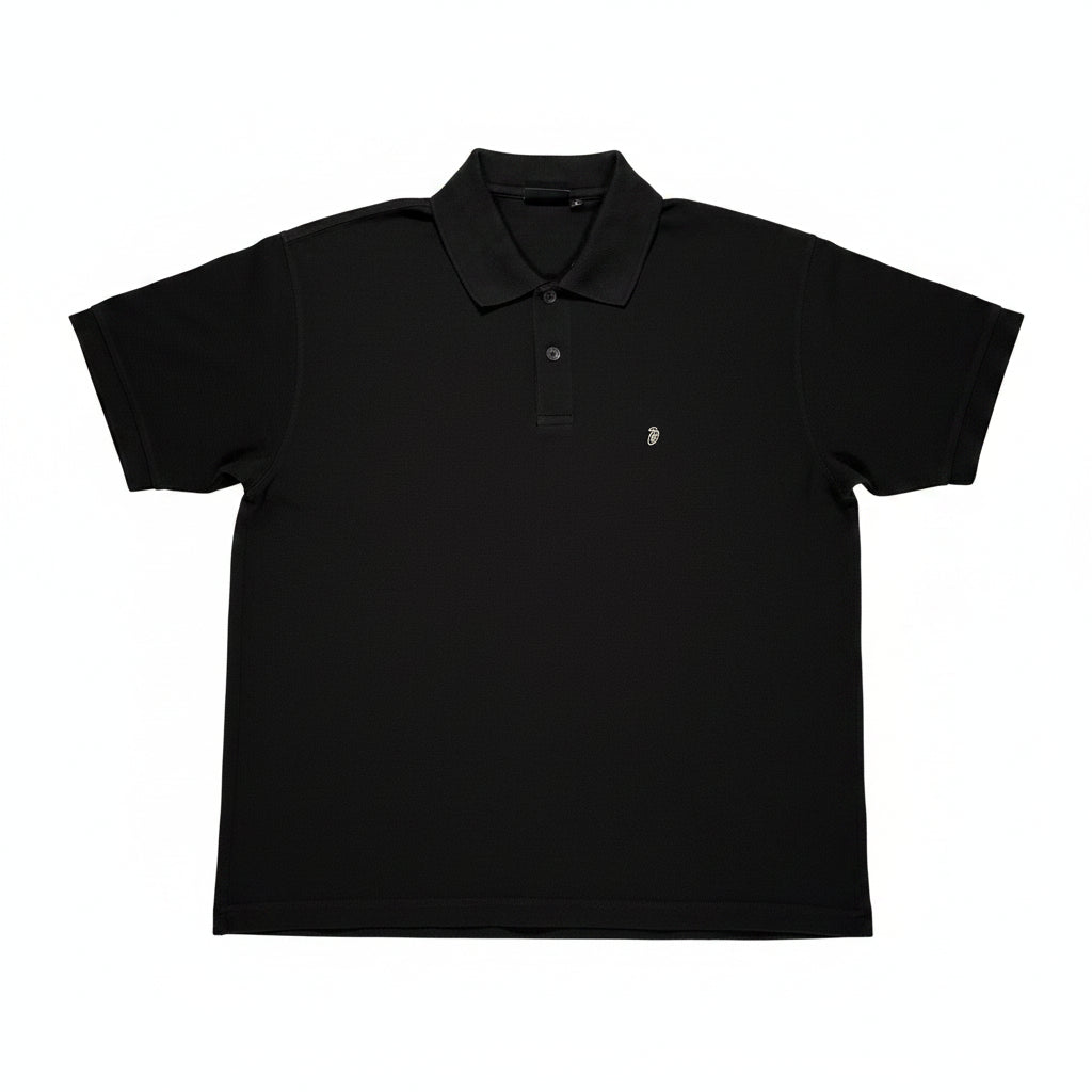 Black polo shirt on a white surface