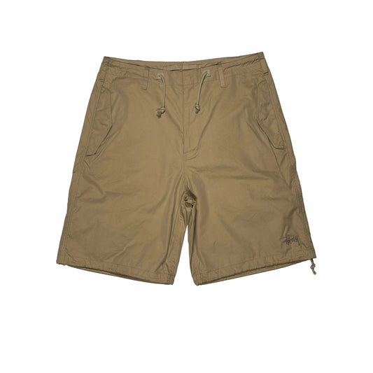 Khaki shorts on a white surface 