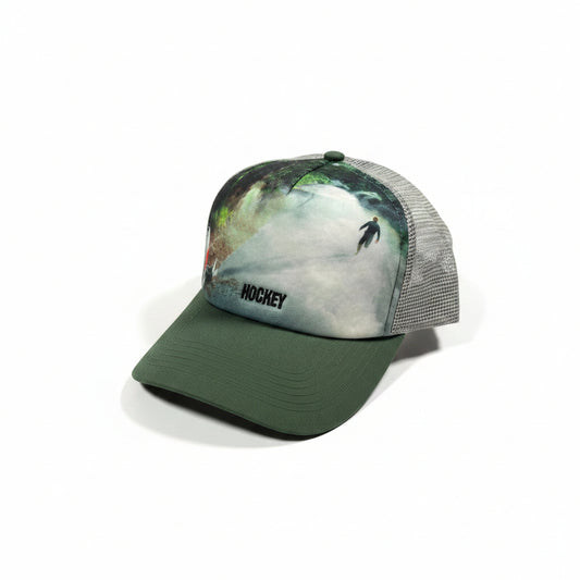 Green cap with a printed design on a white surface