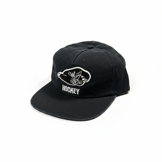 Black cap with white logo and text on a white surface