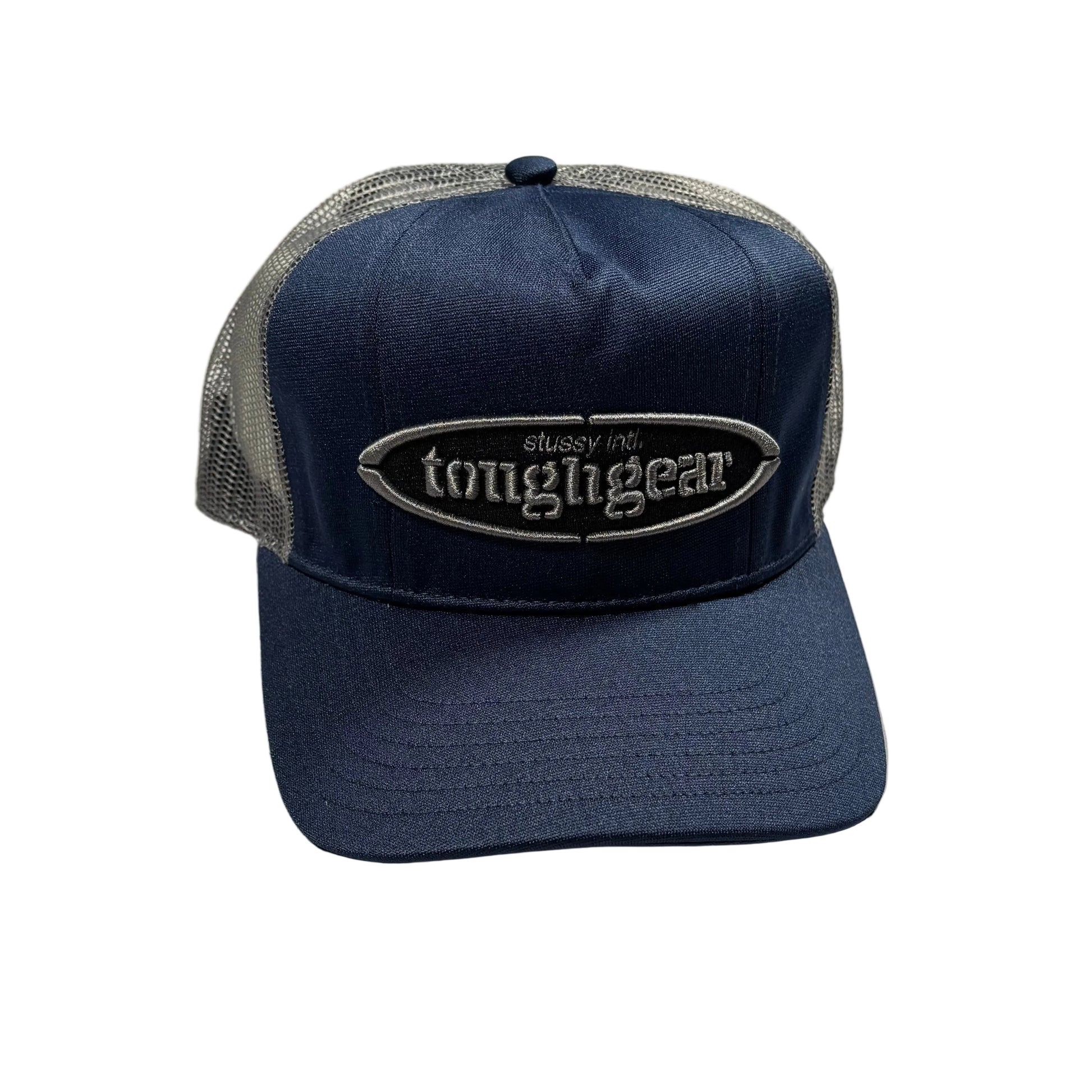 Navy blue cap with mesh back and stussy oval brand logo on a white surface