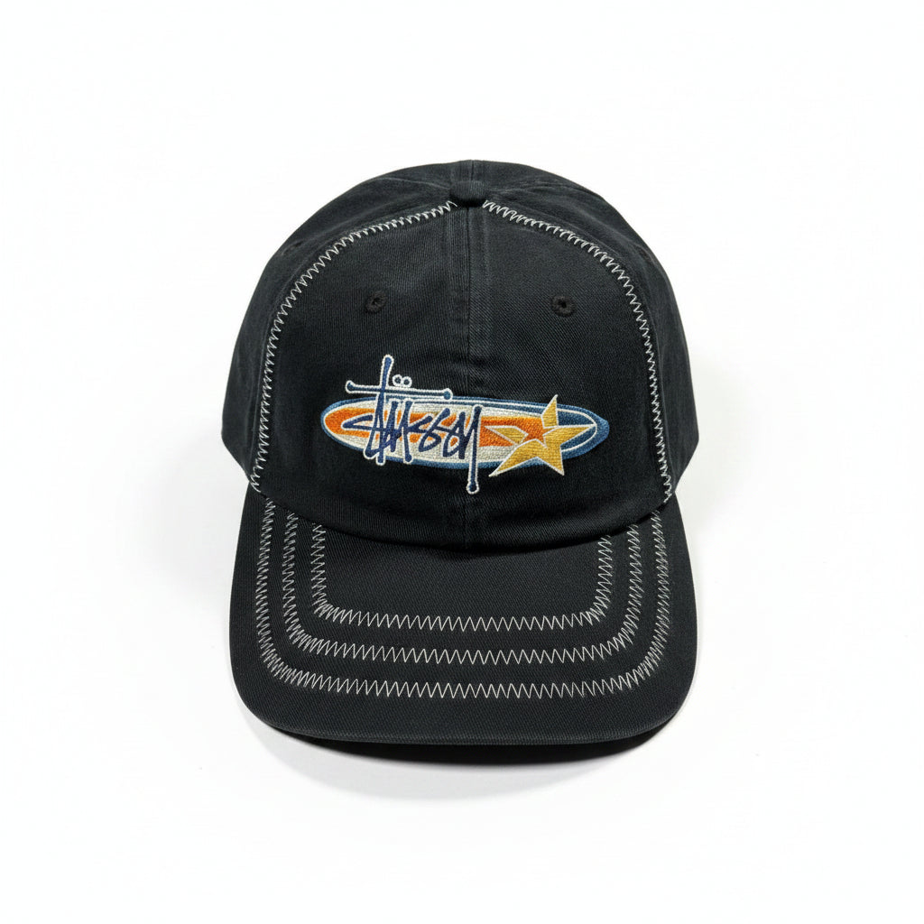 Black cap with embroidered design on a white surface