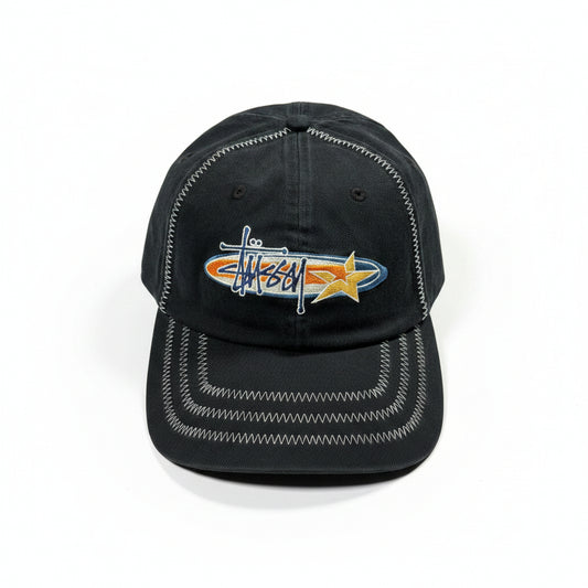 Black cap with embroidered design on a white surface