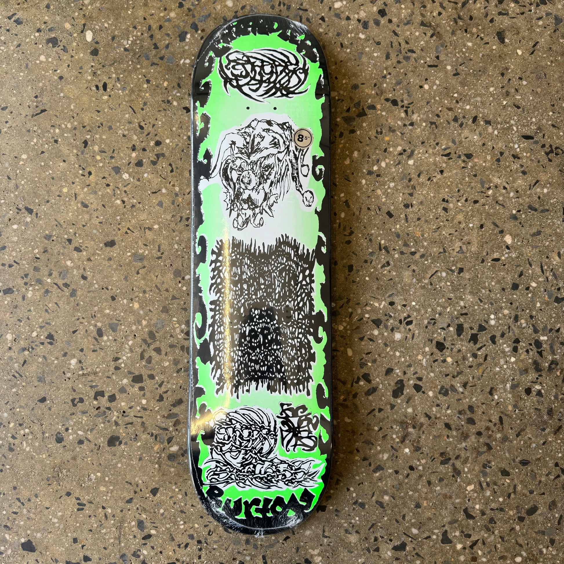 black and green skateboard deck with hardcore/metal font and imagery 