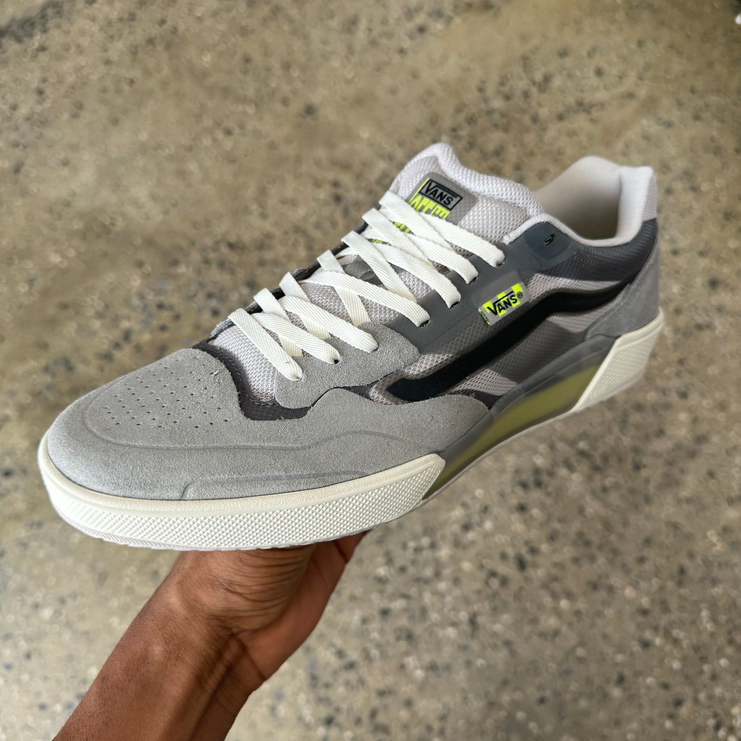 grey suede shoe with black vans stripe and white shoe sole