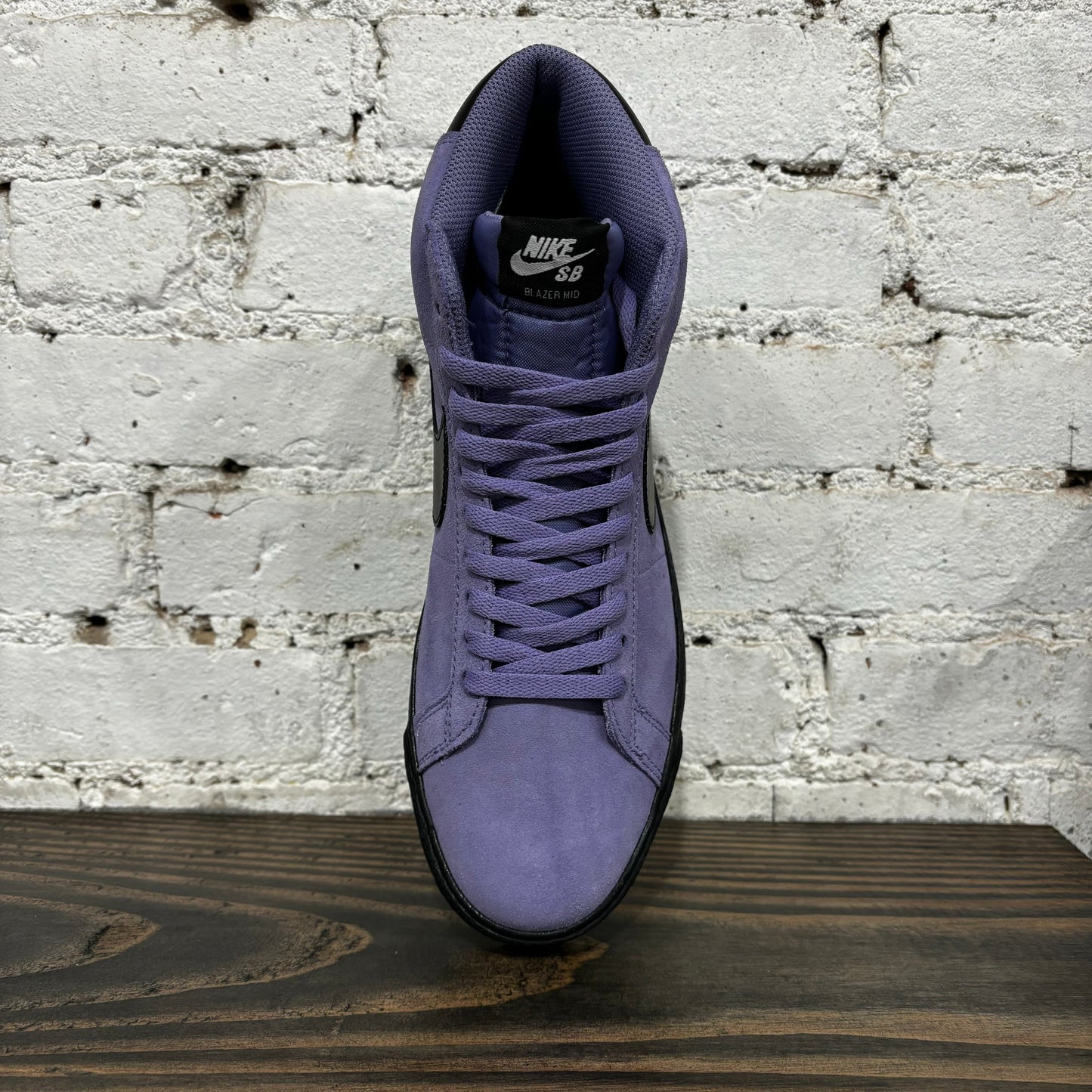 top down view of purple suede mid top skateboard shoe