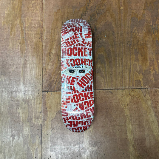 multi color collage of tape across and around skateboard deck with HOCKEY written on it