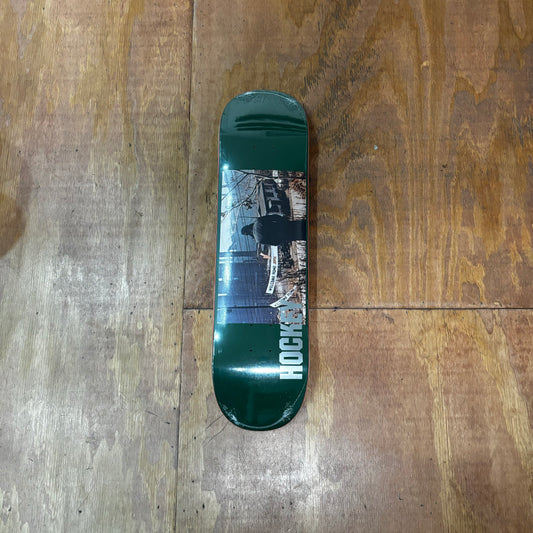 green background skate deck with photo in center of deck