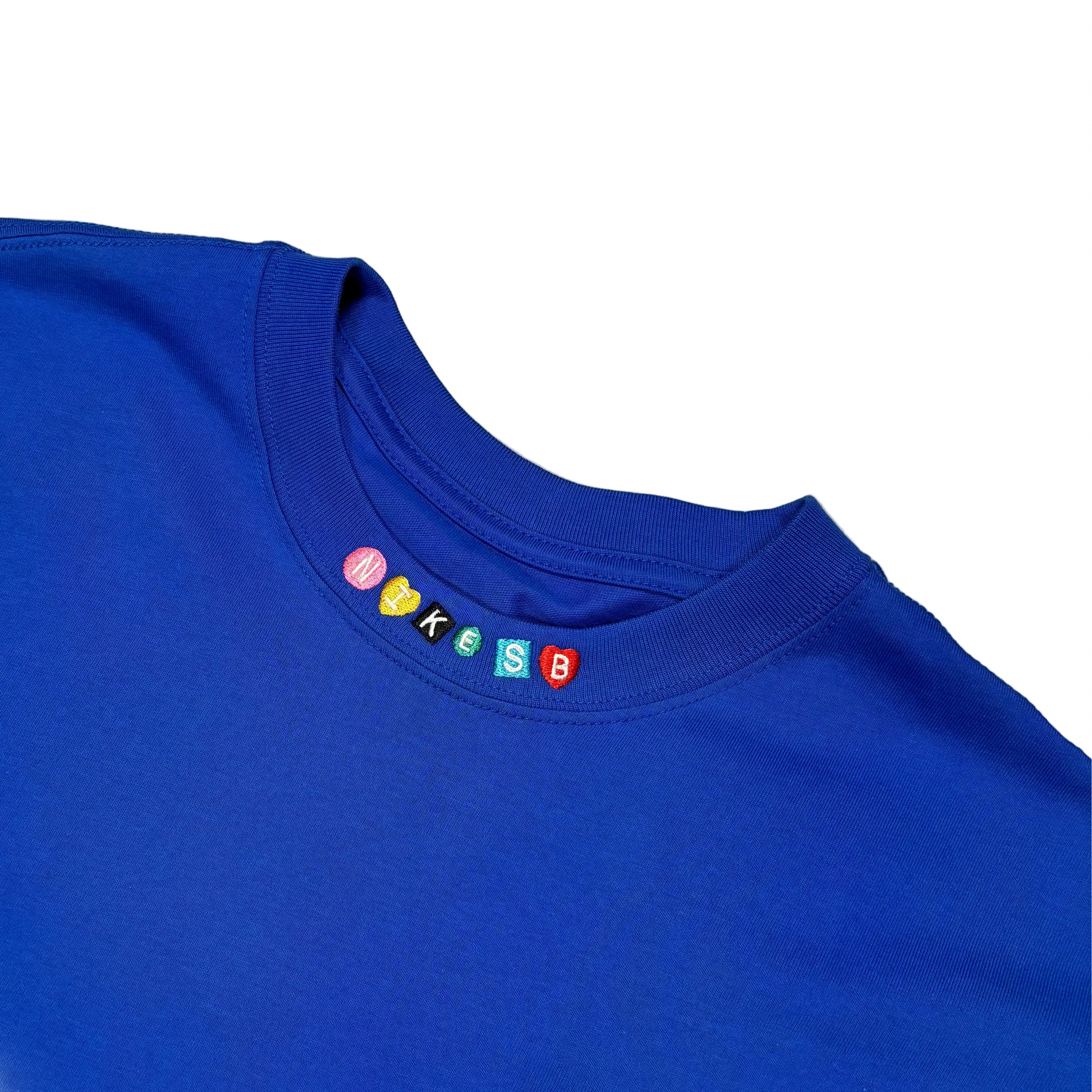 close up view of NIKE SB logo on neckline of shirt