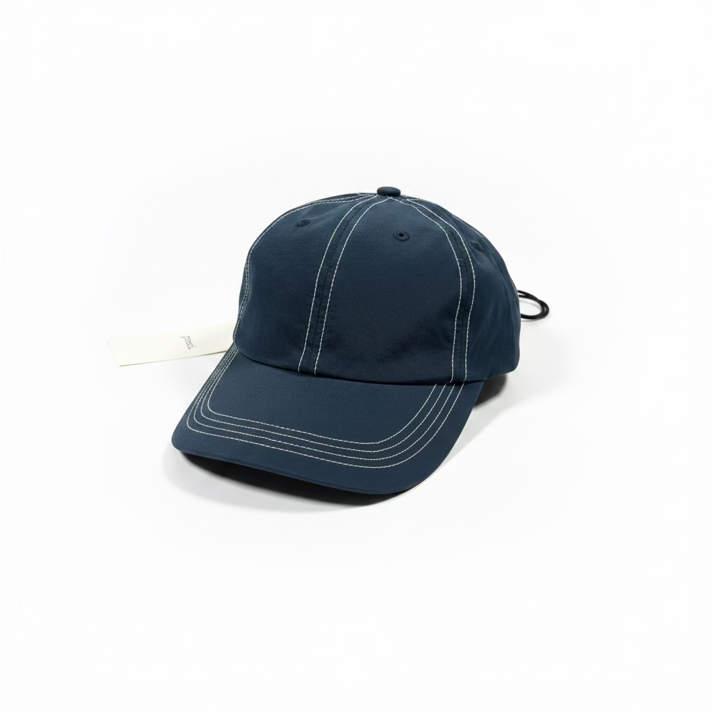 navy blue nylon cap with contrast stitching on white background