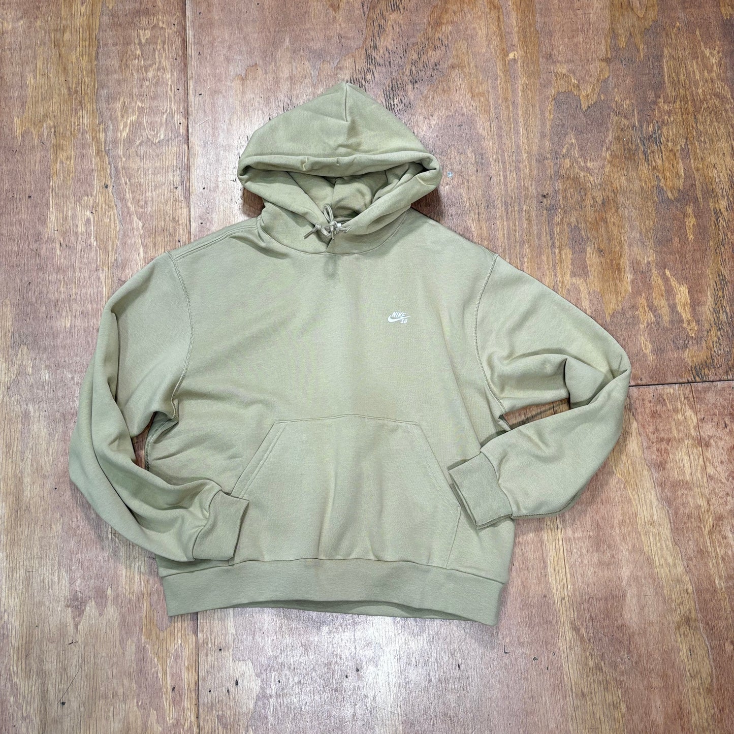 Sand colored pullover hoodie with small NIKE SB embroidered logo on left chest